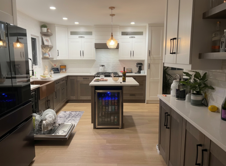Modern custom basement suite kitchen built by Hand and Hammer in Cranbrook, BC, featuring two-tone cabinetry, a copper apron sink, and a center island.